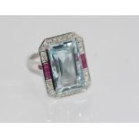 18ct gold, ruby and aquamarine & diamond ring aquamarine = 10.46 cts, 12 princess cut rubies, 26