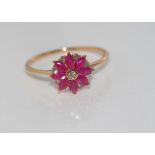 18ct rose gold, ruby and diamond daisy ring rubies = 60 points,9 diamonds = 13 points, weight: