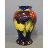 Moorcroft leaves and berries vase with factory marks, signature and paper label to base, 15cm high