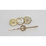 Two vintage brooches comprising a silver coin brooch and a metal ring/bar brooch