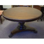 Early Victorian mahogany table with round top supported by a turned column and trefoil platform