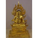 Tibetan gilt bronze figure of a seated Buddha holding an upright sword, H36cm approx