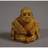 Antique Japanese ivory netsuke depicting a man holding a fan, signed to base, 4cm high approx. NB