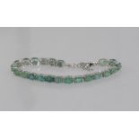 Sterling silver and emerald tennis bracelet