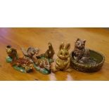 Seven assorted miniature Wade animal figures comprising 5 dinosaurs, honey bunny and cat in basket