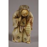 Antique Japanese ivory netsuke depicting a man with revolving face, signed to base, 5cm high approx.