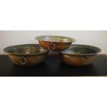 Three antique Persian copper cooking pans with worn tin plating, 44cm diameter (largest)