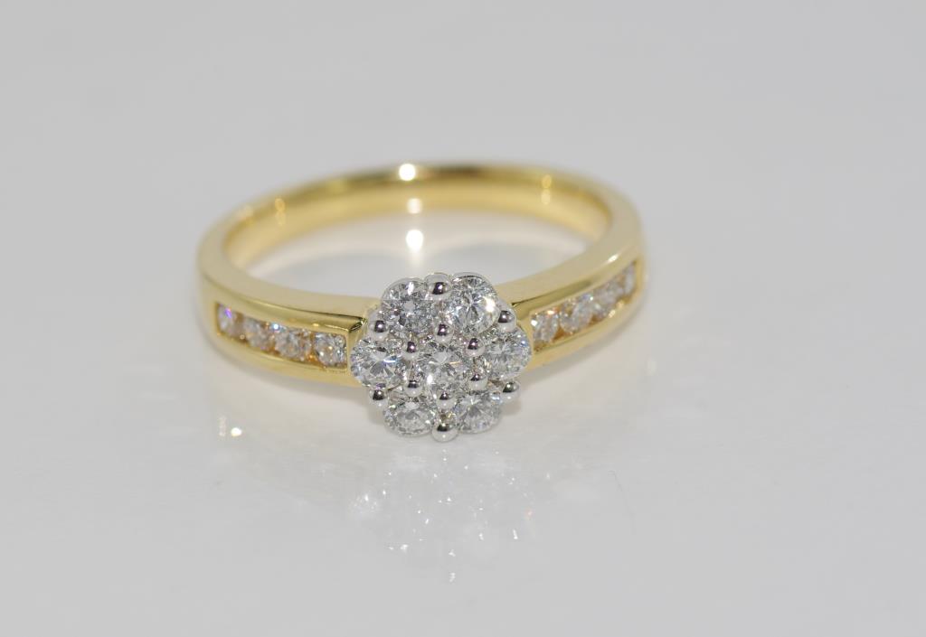 18ct two tone gold and diamond ring with cluster and shoulder diamonds total= 0.50cts H/ Si 1,
