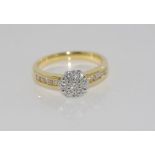 18ct two tone gold and diamond ring with cluster and shoulder diamonds total= 0.50cts H/ Si 1,