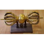 Large Tibetan metal Vajra Dorje on timber stand (ritual weapon meaning thunderbolt or diamond), with