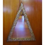 Triangular carved timber framed mirror the frame with aged gold and silver leaf finish, 91.5cm wide,