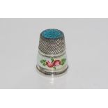 Silver and enamel thimble with blue enamel to top and white with flower around the rim