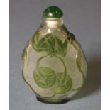 Chinese carved glass snuff bottle with green overlay