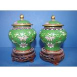 Two Chinese cloisonne lidded jars on timber stands, 14cm high approx.