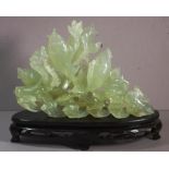 Chinese carved green stone goldfish figure on carved timber base, H22cm approx