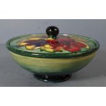 Walter Moorcroft lidded bowl Anemone pattern on green ground. D16cms H9cms approx.