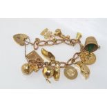 9ct rose gold charm bracelet converted from fob chain , with a variety of yellow gold charms and a