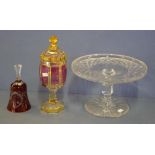 Three various crystal glass items including cake stand; flashed glass lidded urn; & ruby glass