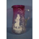 Early Mary Gregory cranberry glass jug 21cm high approx., chip to spout