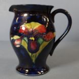 Walter Moorcroft Orchid Jug Orchid pattern on blue ground. Original paper label to base. H16cms