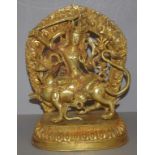Tibetan gilt metal Manjushri figure riding on a mythical beast, (the god of divine wisdom), H30cm