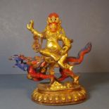 Tibetan gilt metal Yama on mythical dragon 19.5cm high