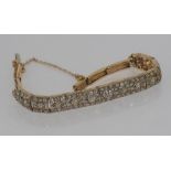 18ct two tone gold and diamond bracelet stamped "18ct" "Englishmade", total weight: 15 grams, 83