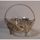 Sterling silver basket with pierced repousse bowl, clear glass liner and rope twist swing handle,