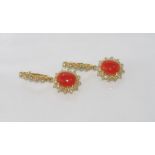 14ct yellow gold, coral and diamond earrings Two orangey-red coral cabochons=4ct, surrounded by 58