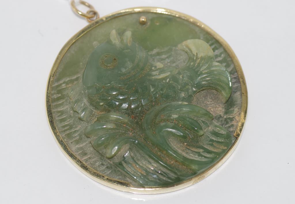 Carved greenstone fish pendant