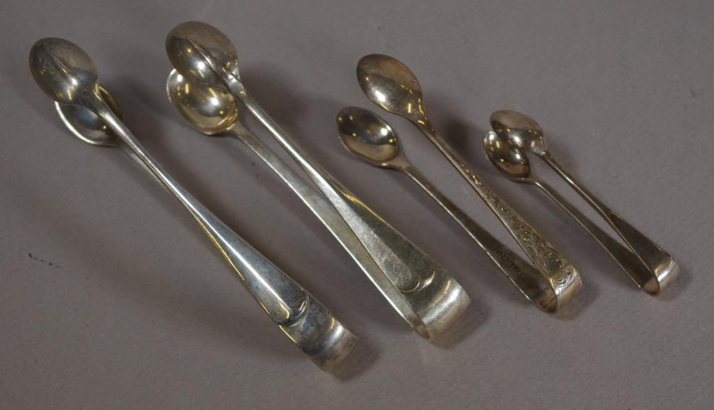 Four various sterling silver sugar tongs