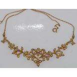 Good antique gold seed pearl flower necklace.