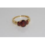 Yellow gold and garnet ring marked 14K
