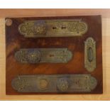 Three ornate Victorian door plates and knobs