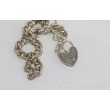 Silver charm bracelet with heart lock