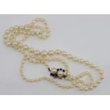 Graduated matinee length strand of cultured pearls