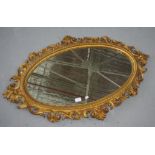 Ornate gilt framed oval mirror