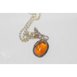 Silver and amber pendant on silver chain