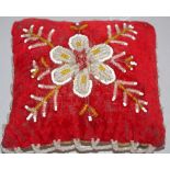 Antique hand embroidered bead cushion.