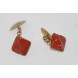Gold cufflinks marked 14K set with red stone