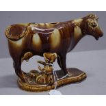 Antique brown glazed cow creamer with milkmaid