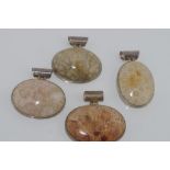 Four silver and stone set pendants