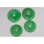 Four various round jade pendants
