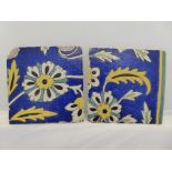 A pair of C17th/18th Safavid tiles with floral and foliate motif on cobalt blue background with