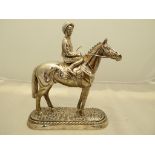 A Sterling Silver clad, filled sculpture of a race horse and mounted jockey