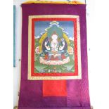 An early C20th Tibetan Thanka of White Tara. Full silk brocade surround with brass hanging pole.