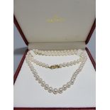 A 1990's single row uniform cultured pearl necklace, by Mikimoto, 14k gold safety clasp, L62cm.