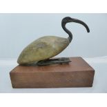 An Egyptian antiquity bronze and carved wood figure of an Ibis on wooden stand the gilt body in