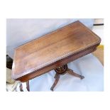 A Regency period rosewood rectangular fold over top card table, rounded corners, brass stringing,