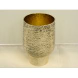 A Hammered Sterling Silver, goblet. Initialed J.A.C. with silver gilt interior on tapred support